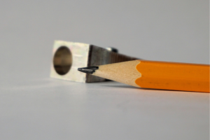 a standard pencil in front a pencil sharpener